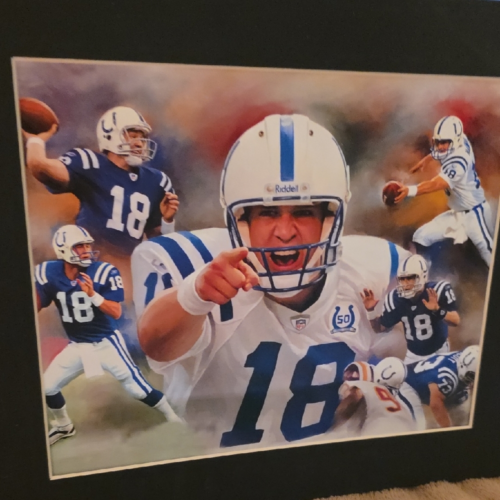 VINTAGE Manning in action, wearing the number 18 jersey and a Riddell helmet
